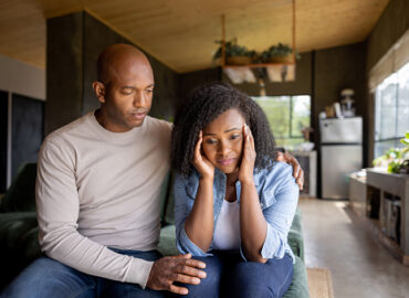istockphoto-1391148902-170667a Loving African American husband consoling his sad wife at home - relationship concepts